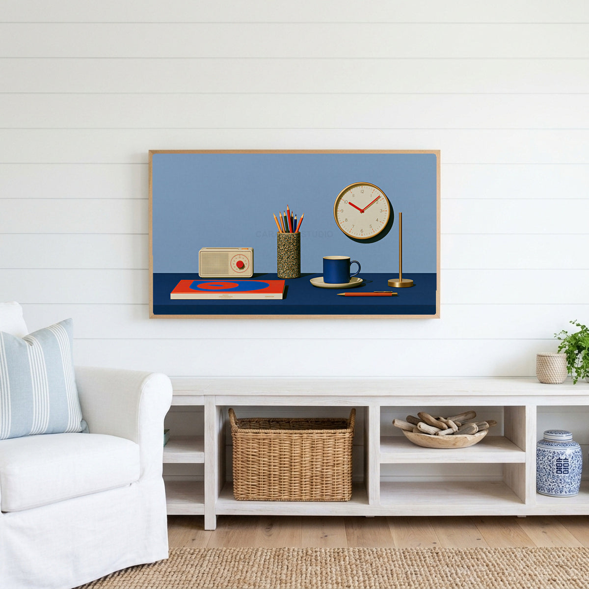 Retro desk, radio and clock Frame TV art above a white console with a rattan basket in a coastal living room