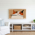 Calico cat face Frame TV art above a white console with a rattan basket in a coastal living room