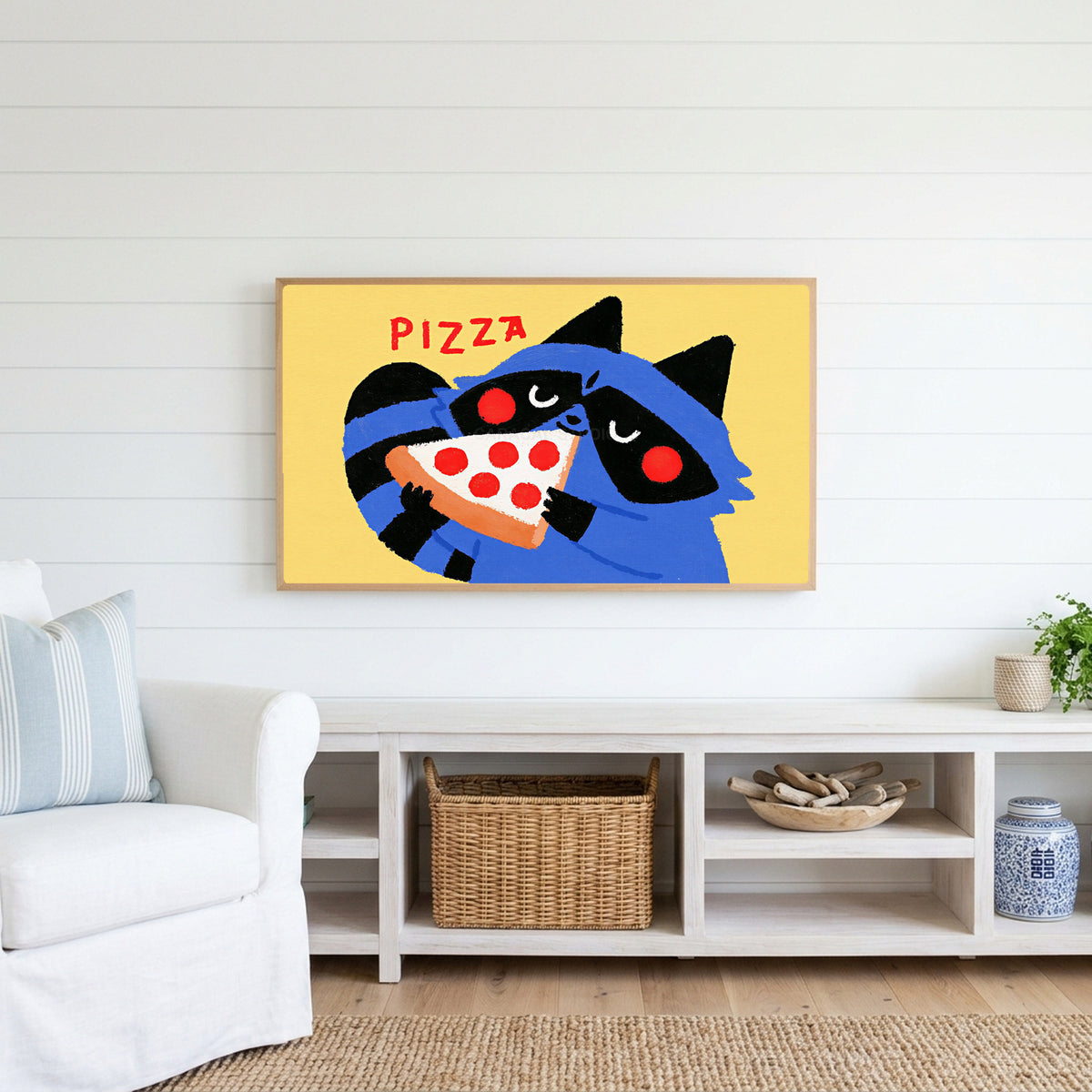 Raccoon pizza Frame TV art above a white console with a rattan basket in a coastal living room