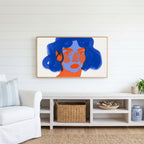 Blue hair portrait Frame TV art above a white console with a rattan basket in a coastal living room
