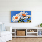 Daisy Frame TV art above a white console with a rattan basket in a coastal living room