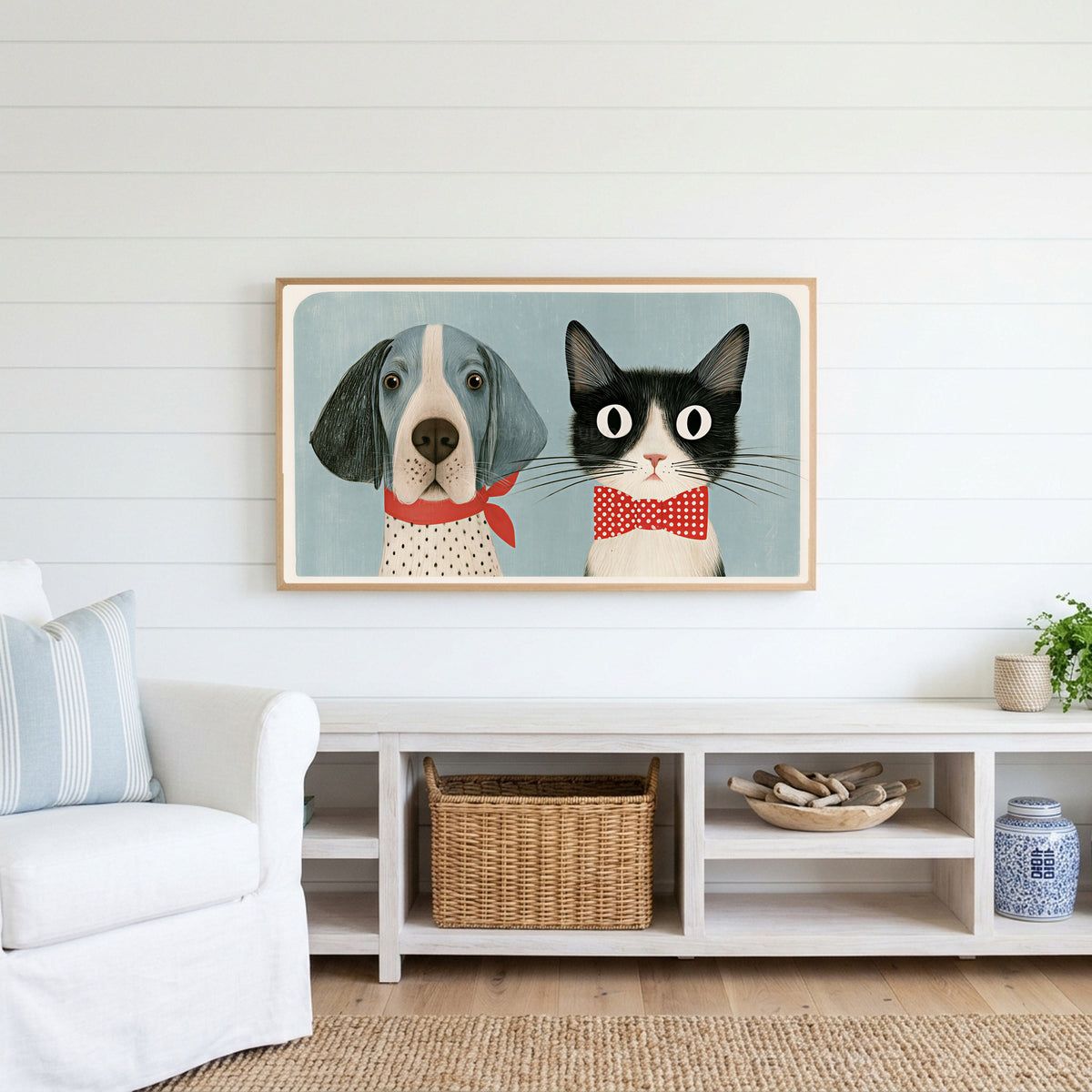 Dog and cat Frame TV art above a white console with a rattan basket in a coastal living room