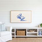 Duckling Frame TV art above a white console with a rattan basket in a coastal living room