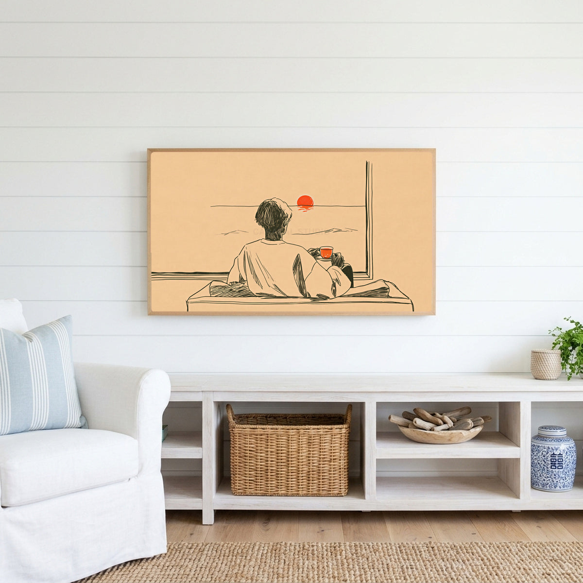 Sunset tea Frame TV art above a white console with a rattan basket in a coastal living room