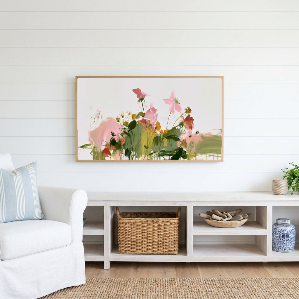 Abstract wildflowers Frame TV art above a white console with a rattan basket in a coastal living room