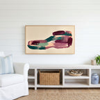 Abstract plum and teal brushstrokes Frame TV art above a white console with a rattan basket in a coastal living room