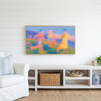 Blurred meadow runners Frame TV art above a white console with a rattan basket in a coastal living room