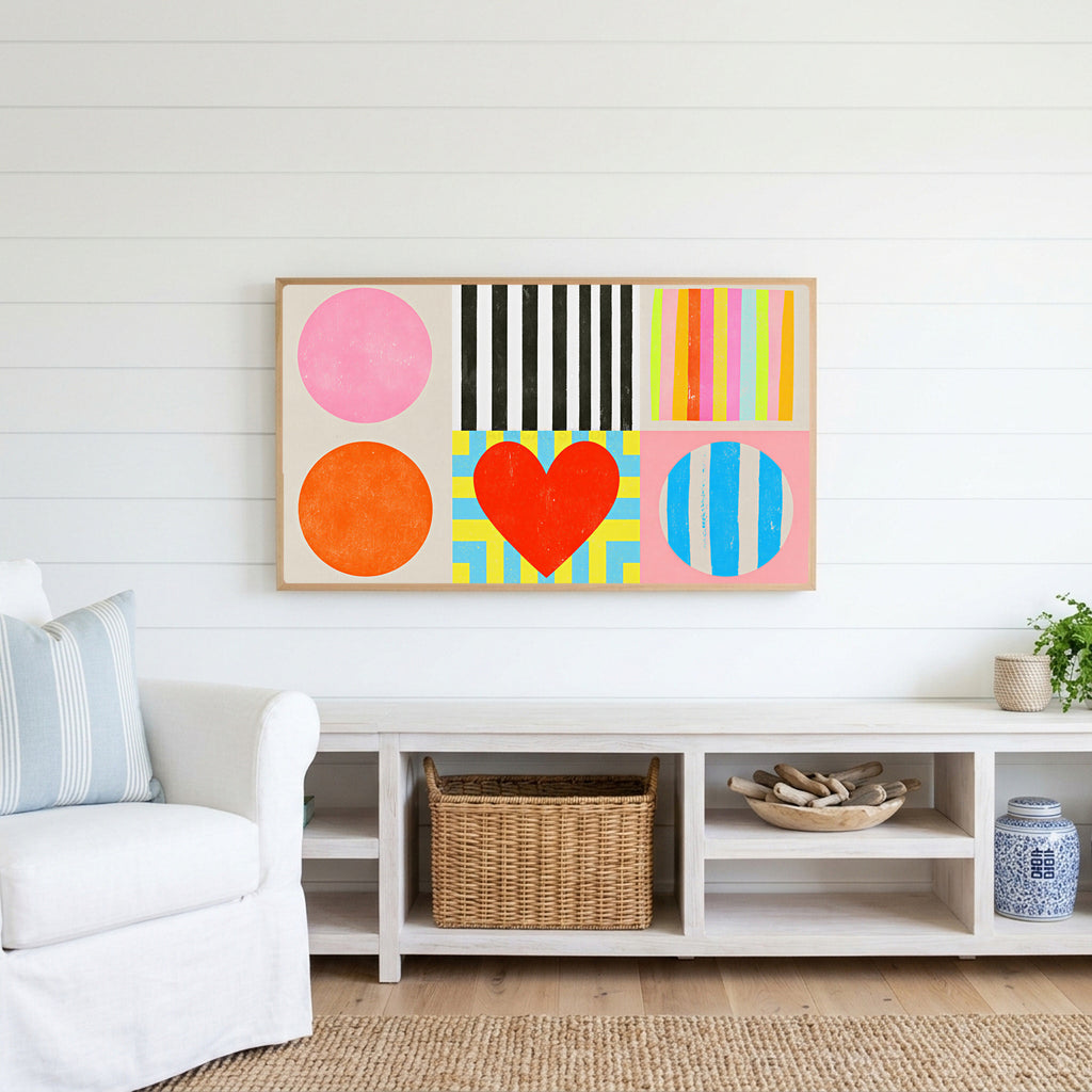Colorful shapes and heart Frame TV art above a white console with a rattan basket in a coastal living room