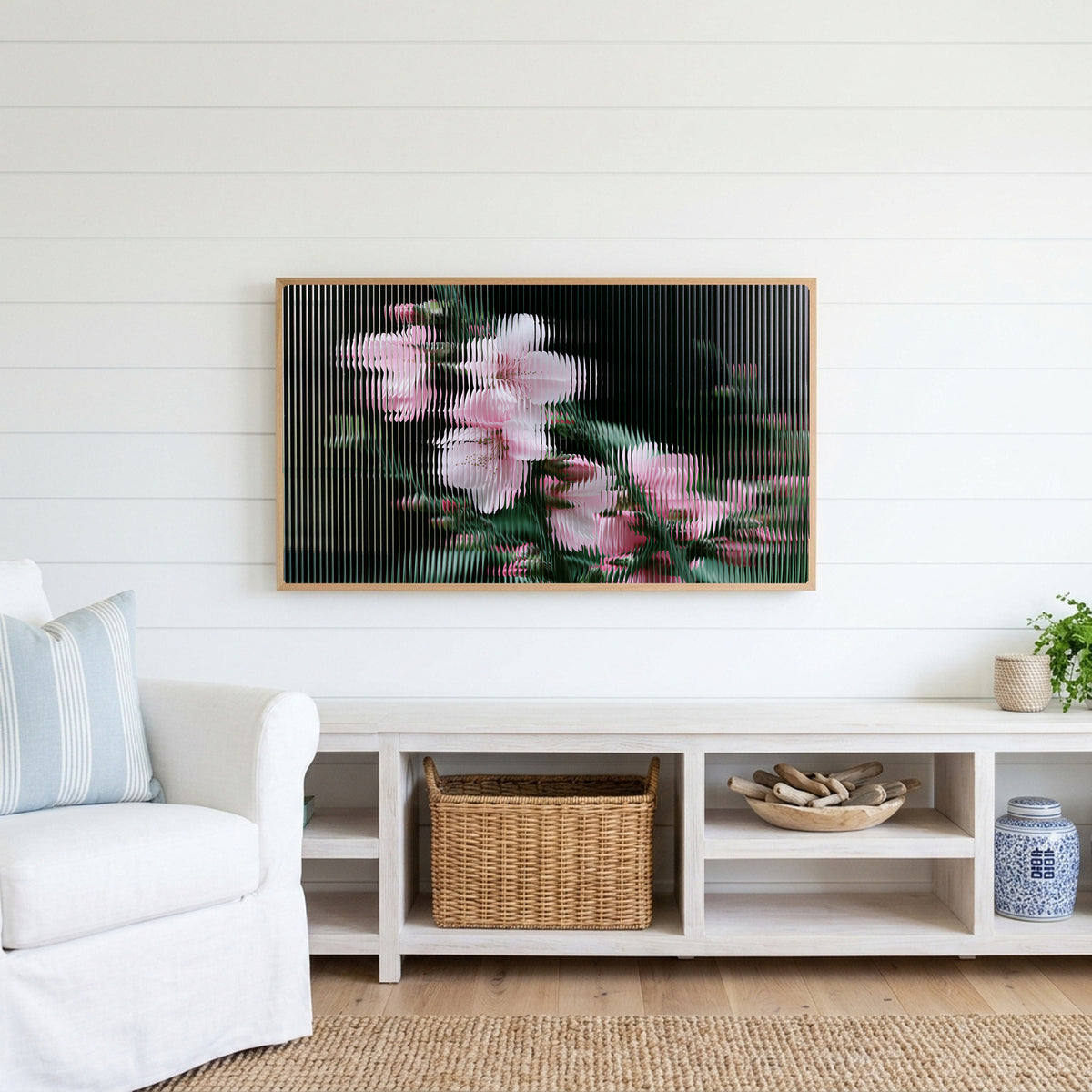 Fluted glass blossom Frame TV art above a white console with a rattan basket in a coastal living room