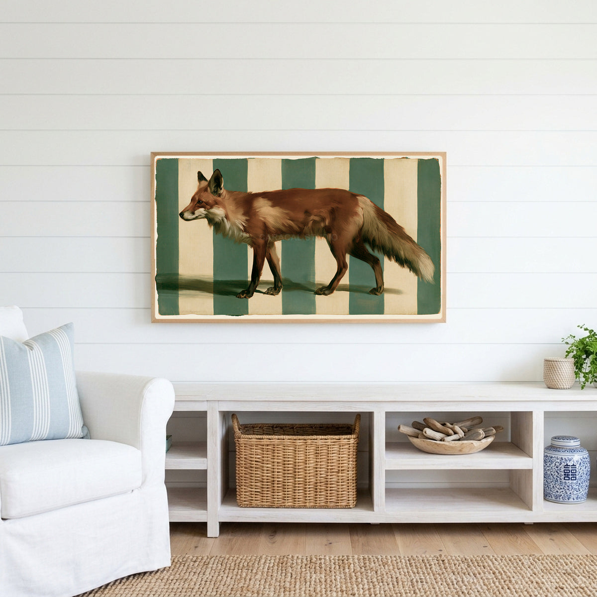 Red fox Frame TV art above a white console with a rattan basket in a coastal living room