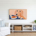 Dog with a croissant Frame TV art above a white console with a rattan basket in a coastal living room