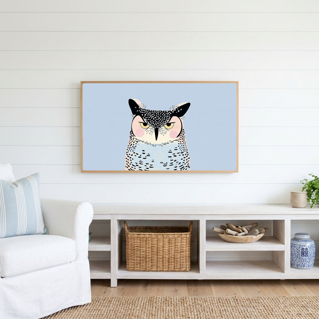 Grumpy owl Frame TV art above a white console with a rattan basket in a coastal living room