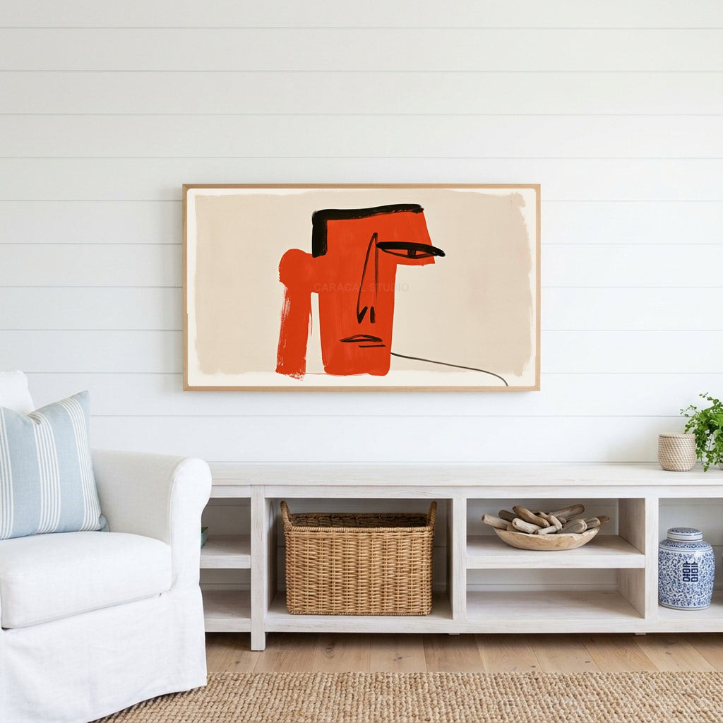 Red block face Frame TV art above a white console with a rattan basket in a coastal living room
