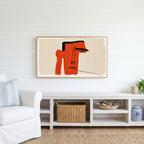 Red block face Frame TV art above a white console with a rattan basket in a coastal living room