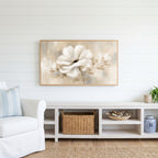 White flower Frame TV art above a white console with a rattan basket in a coastal living room