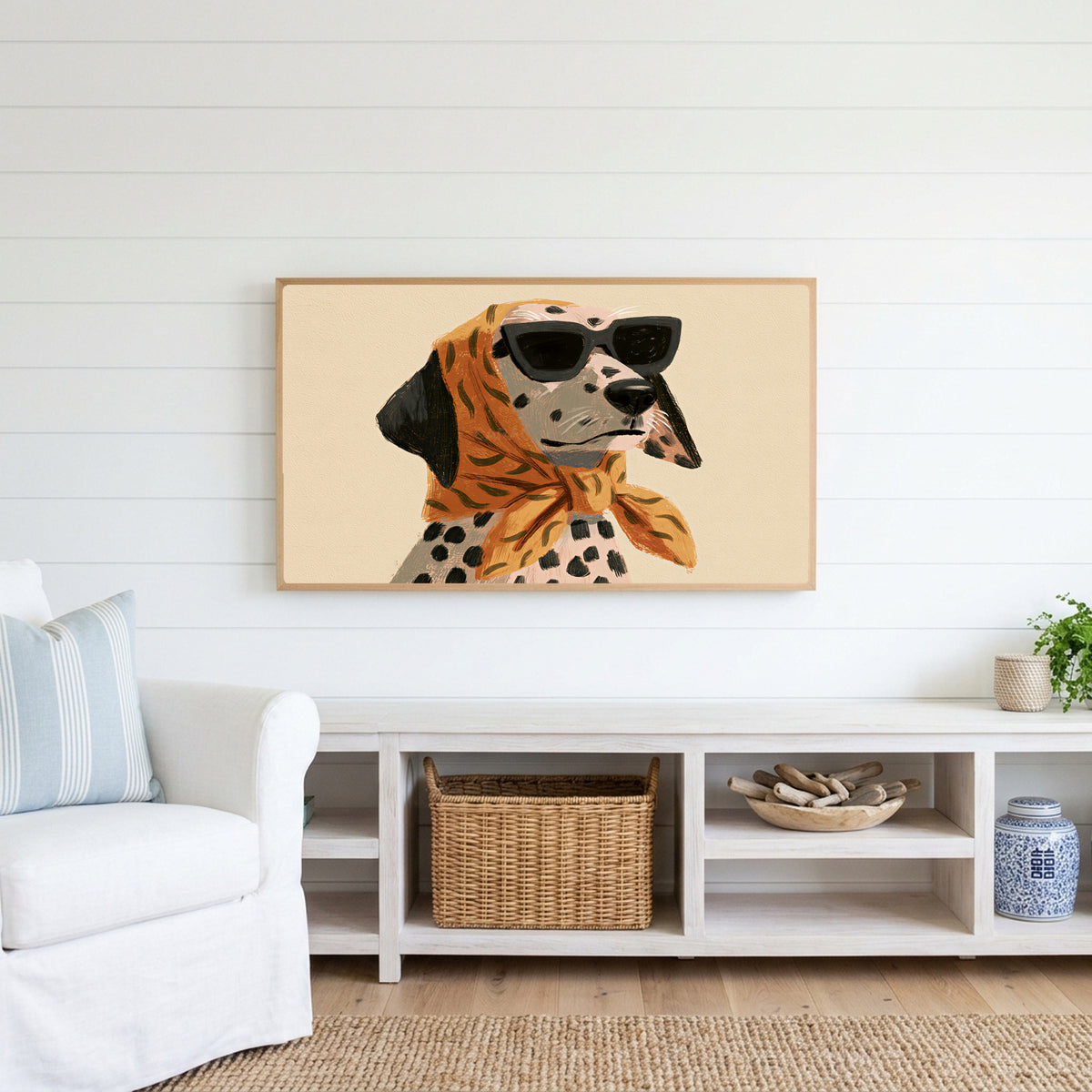 Dalmatian in sunglasses Frame TV art above a white console with a rattan basket in a coastal living room
