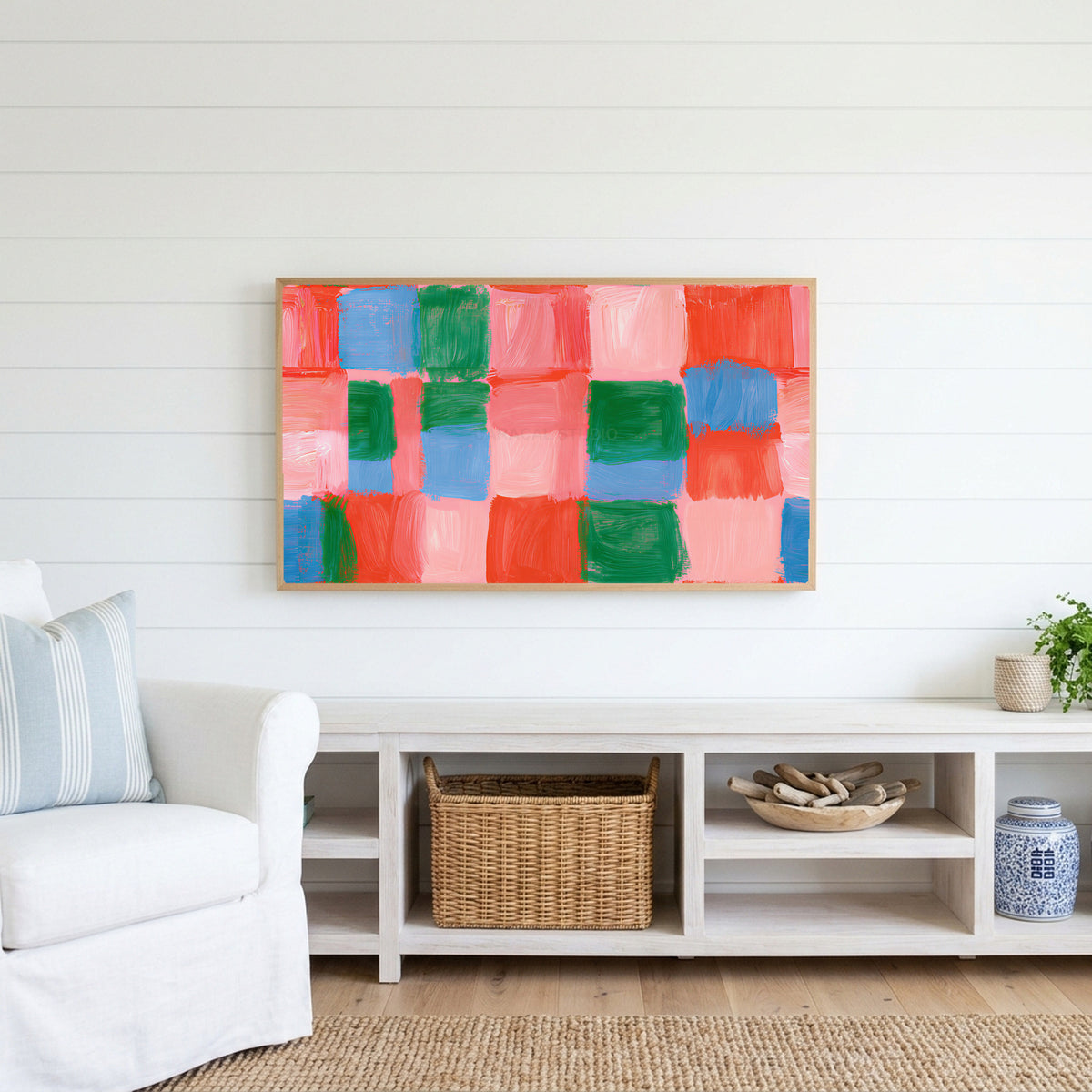 Painted checks Frame TV art above a white console with a rattan basket in a coastal living room