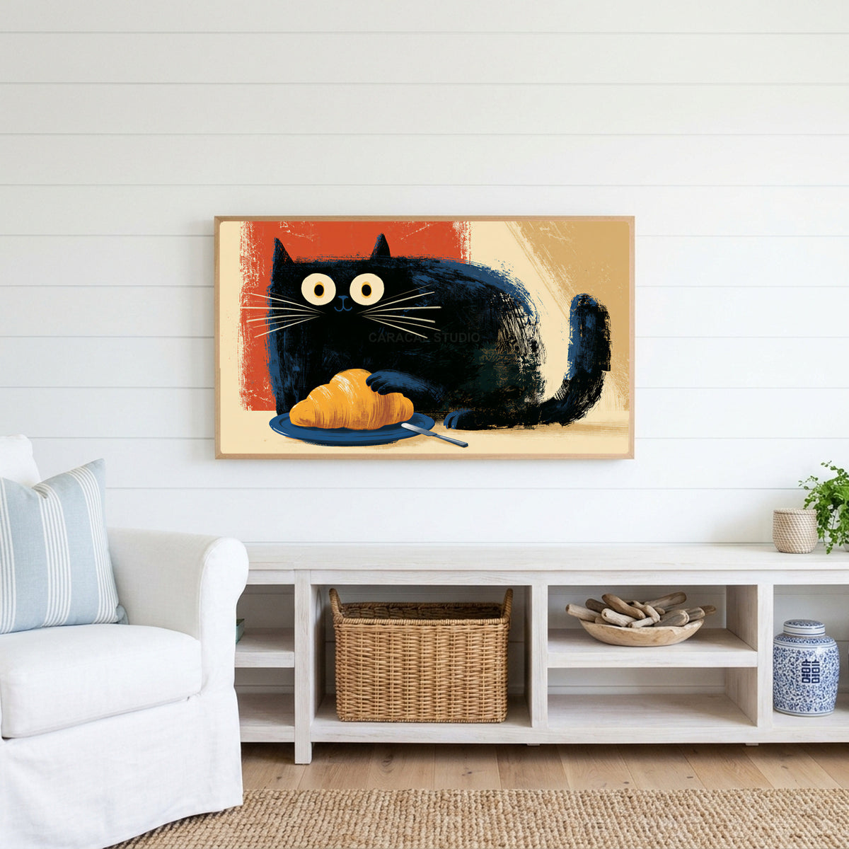Croissant black cat Frame TV art above a white console with a rattan basket in a coastal living room
