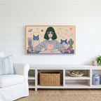Astrology and cats Frame TV art above a white console with a rattan basket in a coastal living room