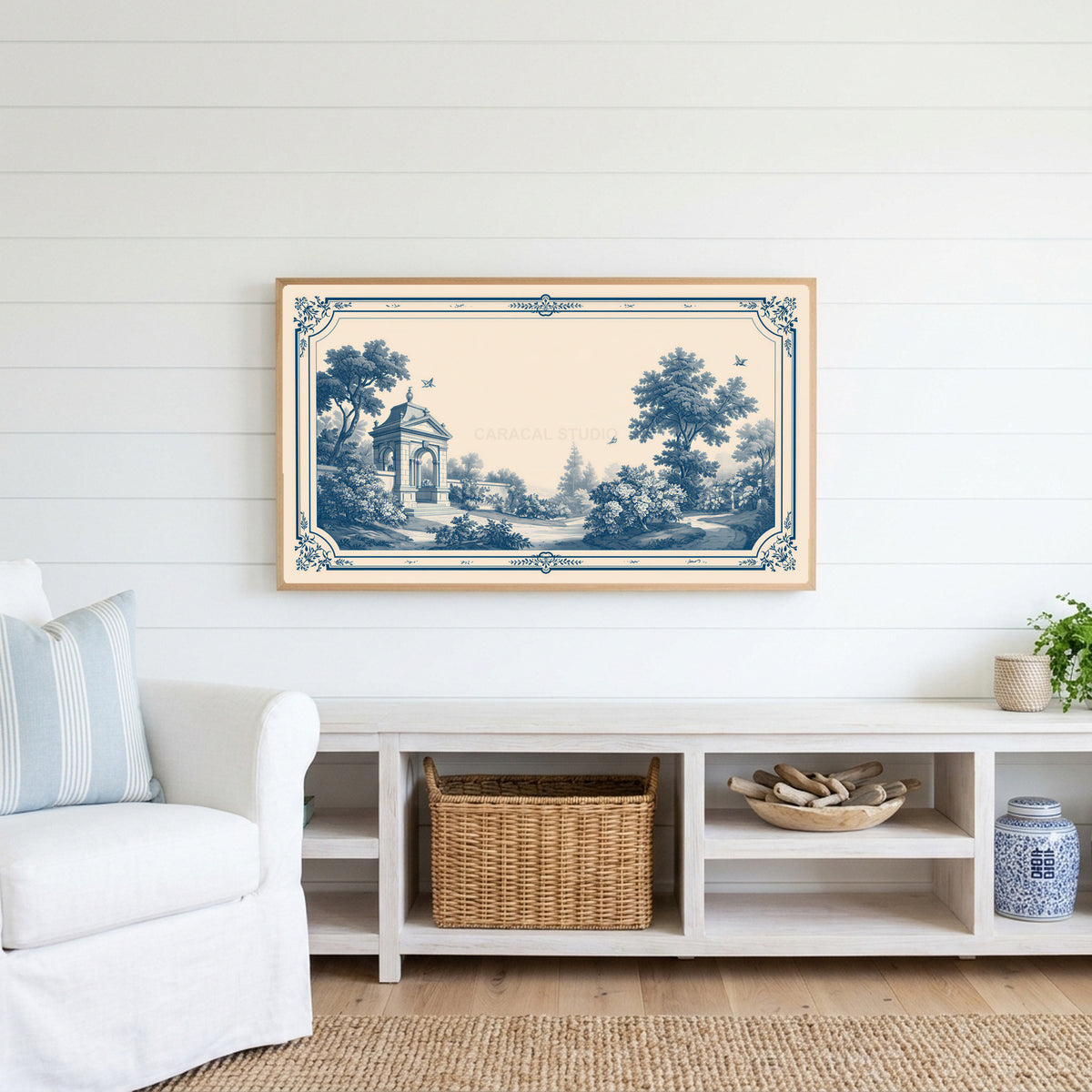Blue toile garden Frame TV art above a white console with a rattan basket in a coastal living room