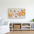 Blossom and orange Frame TV art above a white console with a rattan basket in a coastal living room