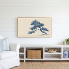 Blue ink tree Frame TV art above a white console with a rattan basket in a coastal living room
