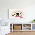 Puppy with a pink scarf Frame TV art above a white console with a rattan basket in a coastal living room
