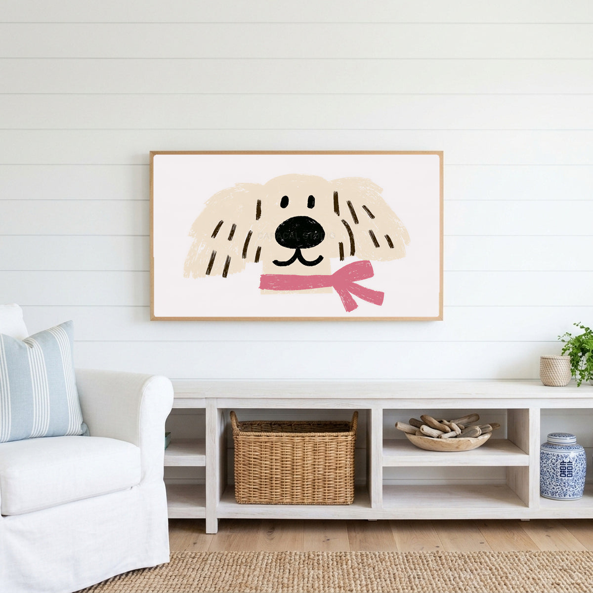 Puppy with a pink scarf Frame TV art above a white console with a rattan basket in a coastal living room