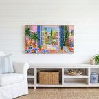 Mediterranean garden view Frame TV art above a white console with a rattan basket in a coastal living room