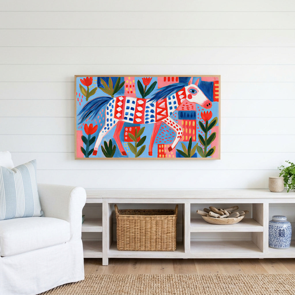 Folk art horse Frame TV art above a white console with a rattan basket in a coastal living room