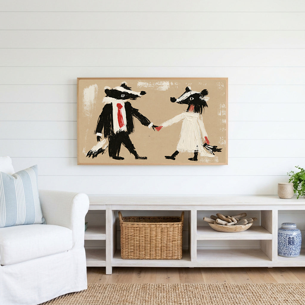 Badger bride and groom Frame TV art above a white console with a rattan basket in a coastal living room
