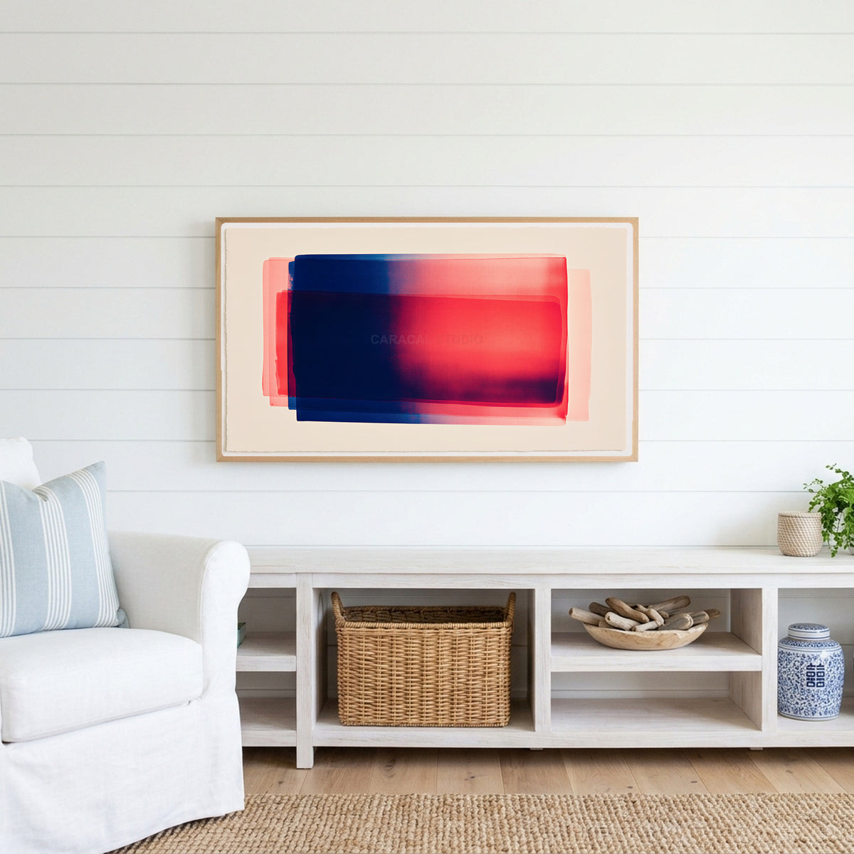 Color field Frame TV art above a white console with a rattan basket in a coastal living room