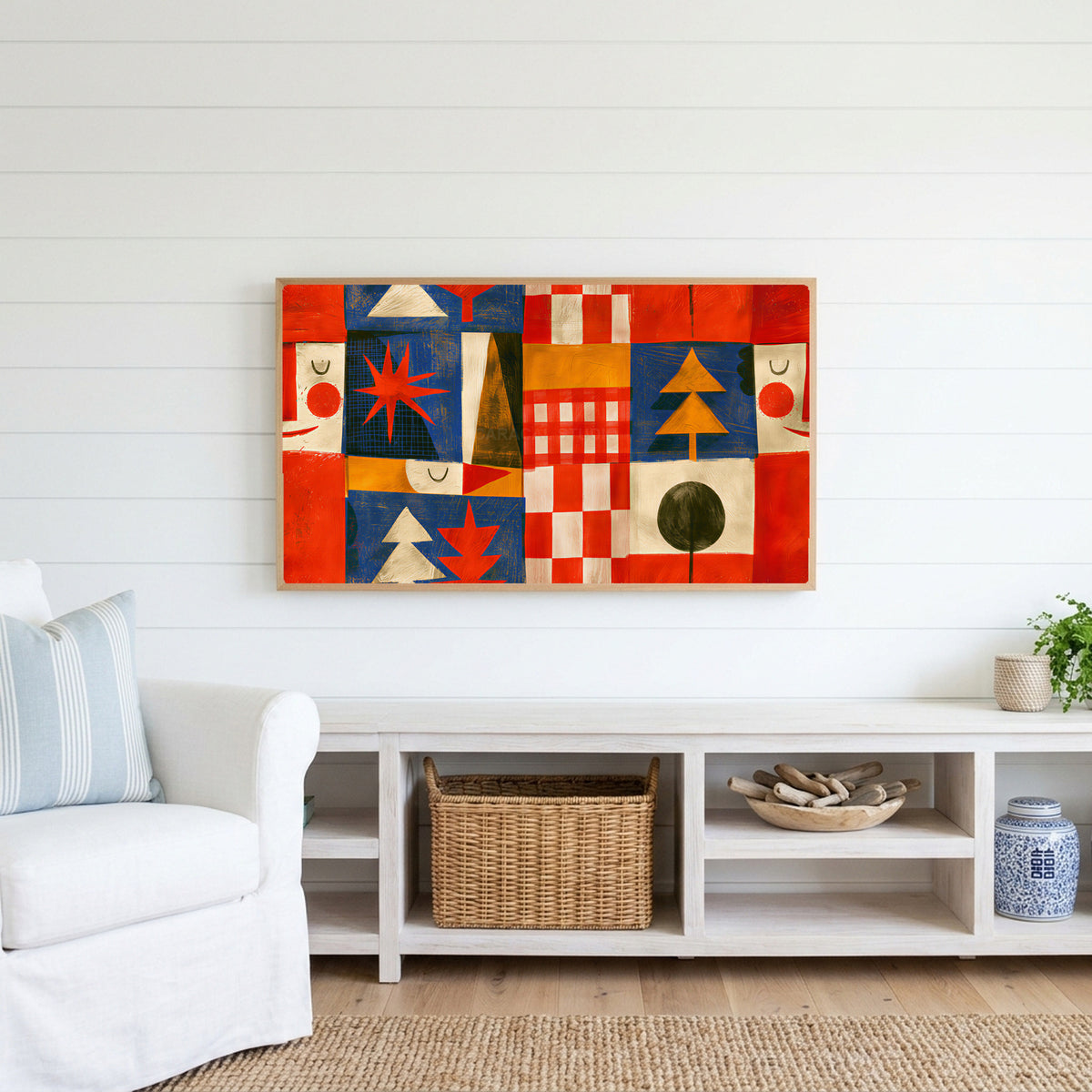 Folk art patchwork Frame TV art above a white console with a rattan basket in a coastal living room