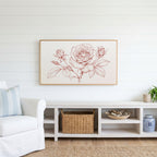 Rose line drawing Frame TV art above a white console with a rattan basket in a coastal living room
