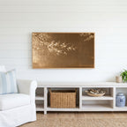 Japanese blossom Frame TV art above a white console with a rattan basket in a coastal living room