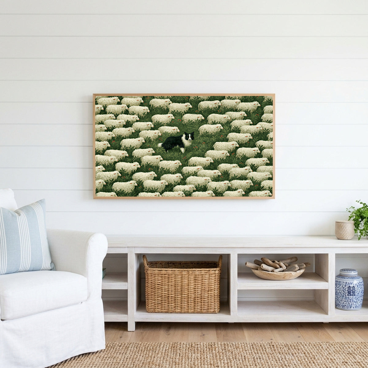 Border collie and sheep Frame TV art above a white console with a rattan basket in a coastal living room