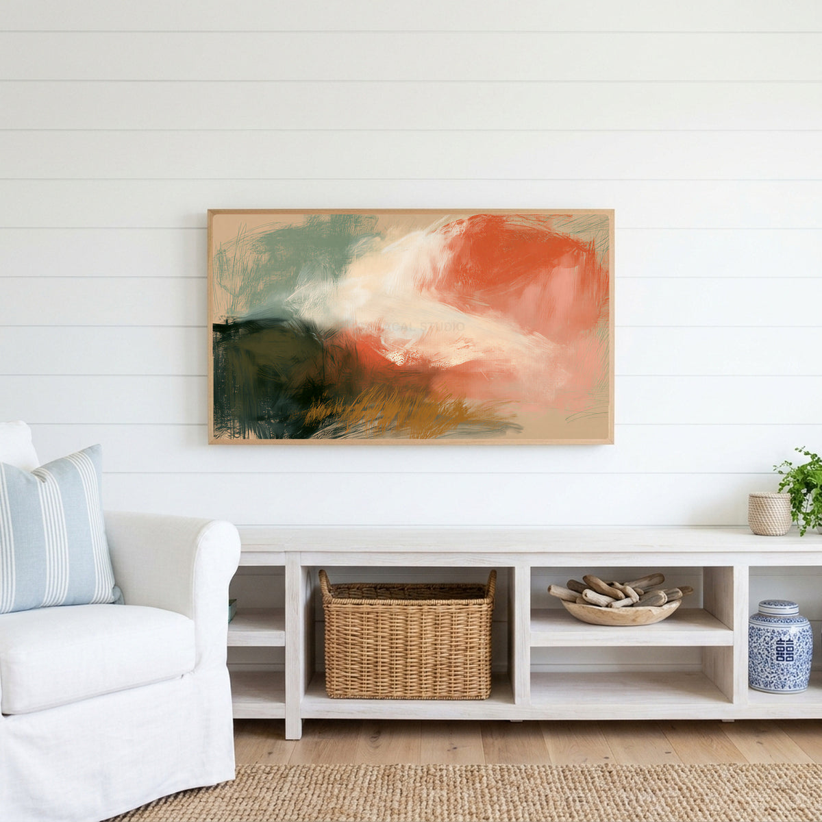 Chalk pastel abstract Frame TV art above a white console with a rattan basket in a coastal living room