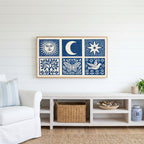 Celestial folk Frame TV art above a white console with a rattan basket in a coastal living room