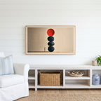 Stacked stones Frame TV art above a white console with a rattan basket in a coastal living room