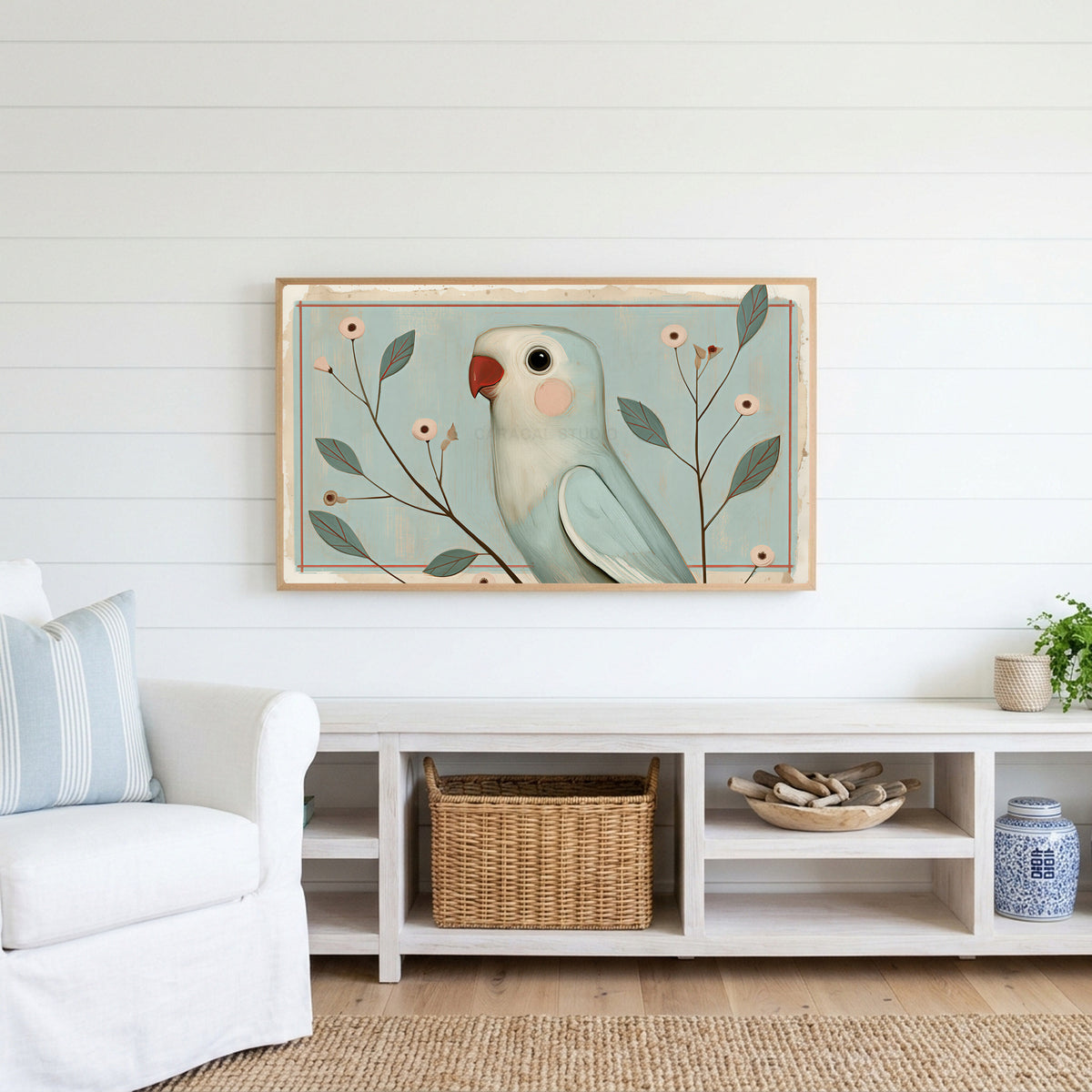 Vintage blue parrot Frame TV art above a white console with a rattan basket in a coastal living room
