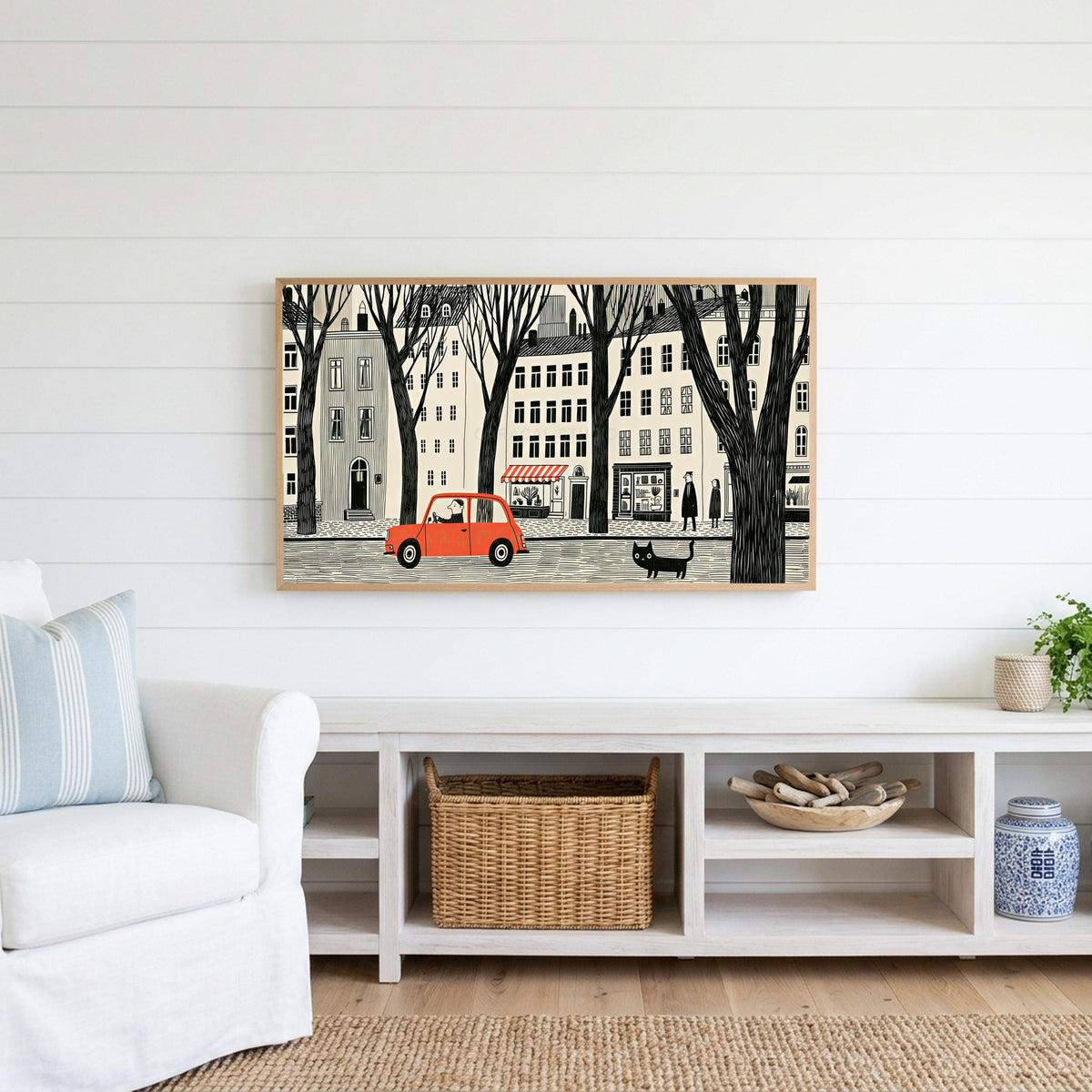 City street Frame TV art above a white console with a rattan basket in a coastal living room