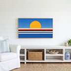 Retro sunset over the sea Frame TV art above a white console with a rattan basket in a coastal living room