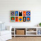 Mid century grid Frame TV art above a white console with a rattan basket in a coastal living room