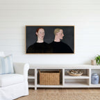 Two women portrait Frame TV art above a white console with a rattan basket in a coastal living room