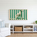 Borzoi Frame TV art above a white console with a rattan basket in a coastal living room