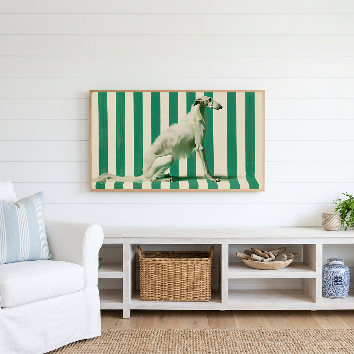 Borzoi Frame TV art above a white console with a rattan basket in a coastal living room