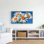 Daisy Frame TV art above a white console with a rattan basket in a coastal living room