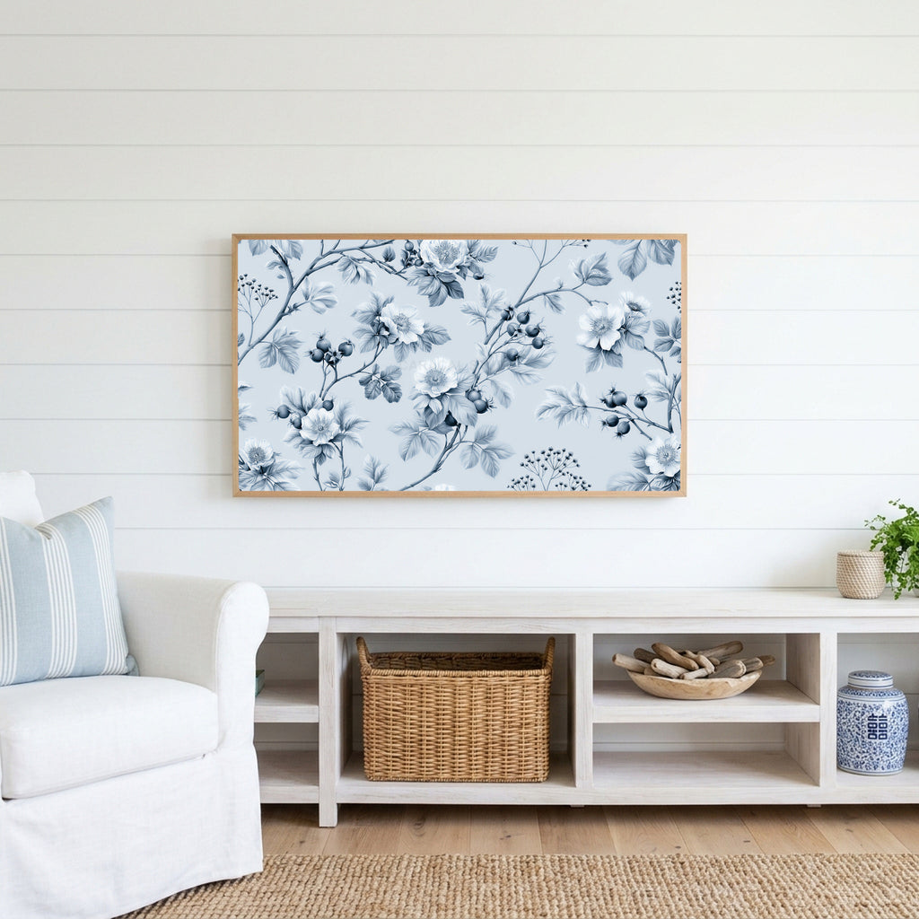 Toile wild roses Frame TV art above a white console with a rattan basket in a coastal living room