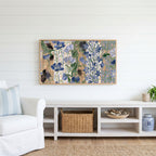 Vintage blue florals Frame TV art above a white console with a rattan basket in a coastal living room