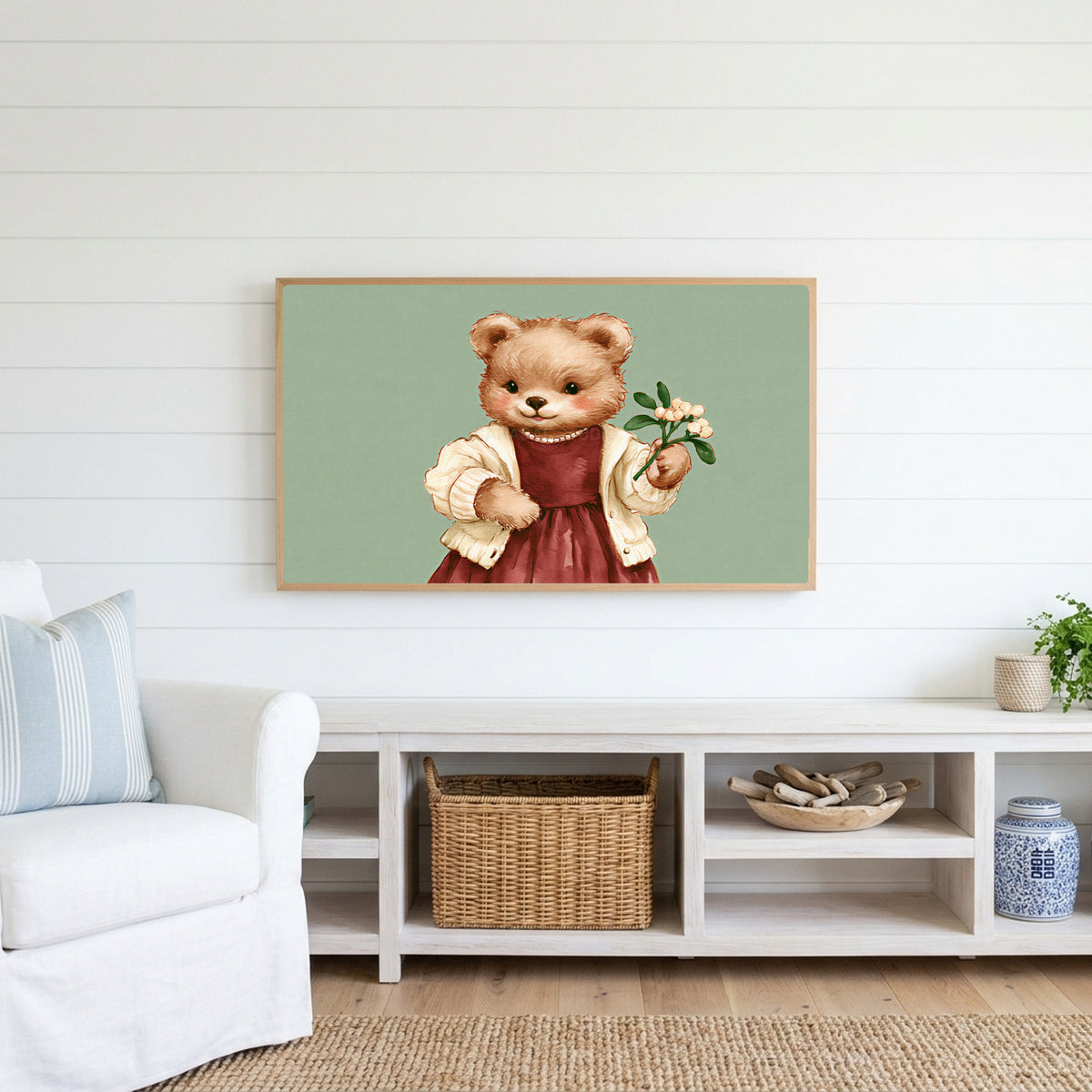 Teddy bear Frame TV art above a white console with a rattan basket in a coastal living room